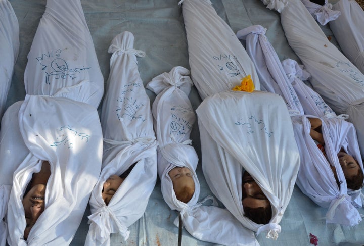 <strong>Bodies of people killed in the attack that Eid survived in 2013 in the Duma neighbourhood of Damascus. </strong>