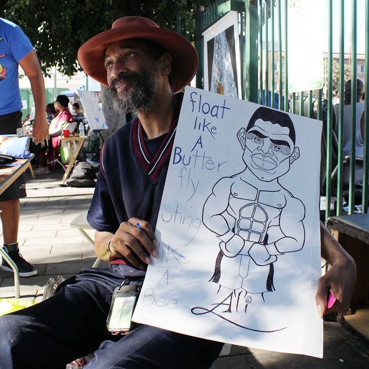 Former animation artist Robert Tolbert is seen with a picture he drew of one of his heroes, Muhammad Ali.