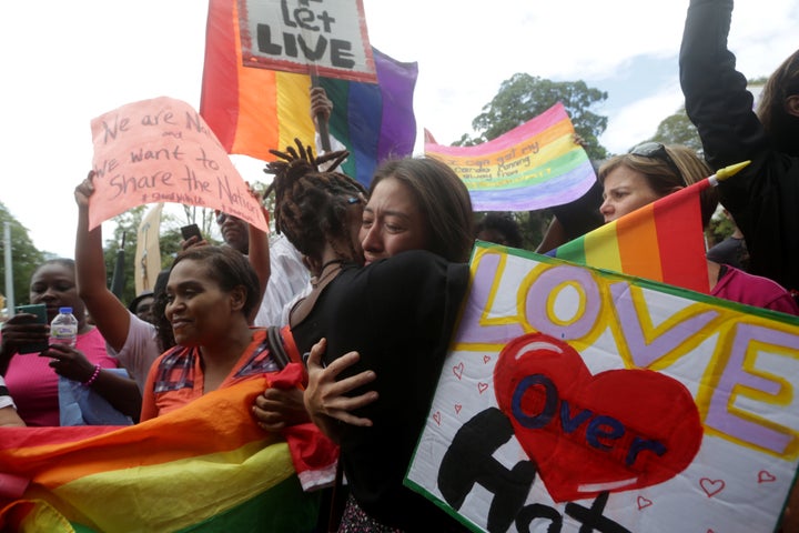 Two demonstrators embrace outside the Hall of Justice in Port-of-Spain, Trinidad and Tobago, on Thursday.