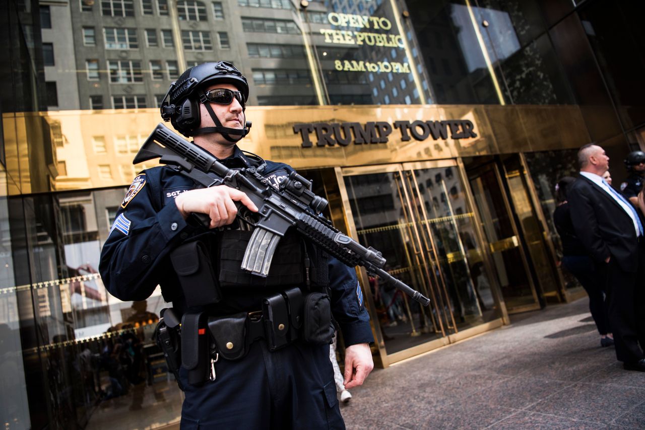 An armed police officer stands guard at the entrance of Trump Tower on April 13. Extra security measures at the building have been a hassle for residents. 