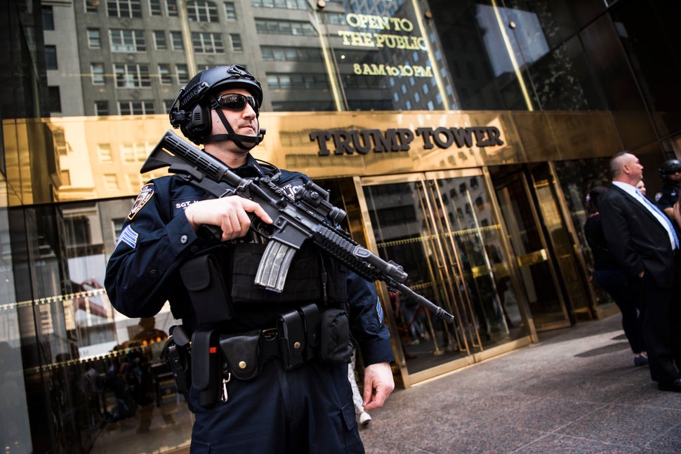 An armed police officer stands guard at the entrance of Trump Tower on April 13. Extra security measures at the building have