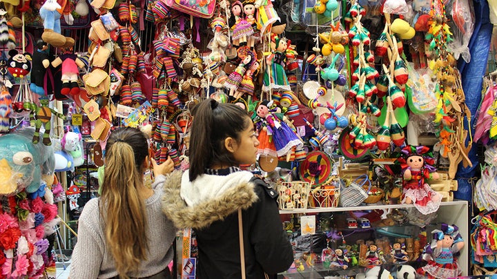 Young girls look at toys in El Mercado.