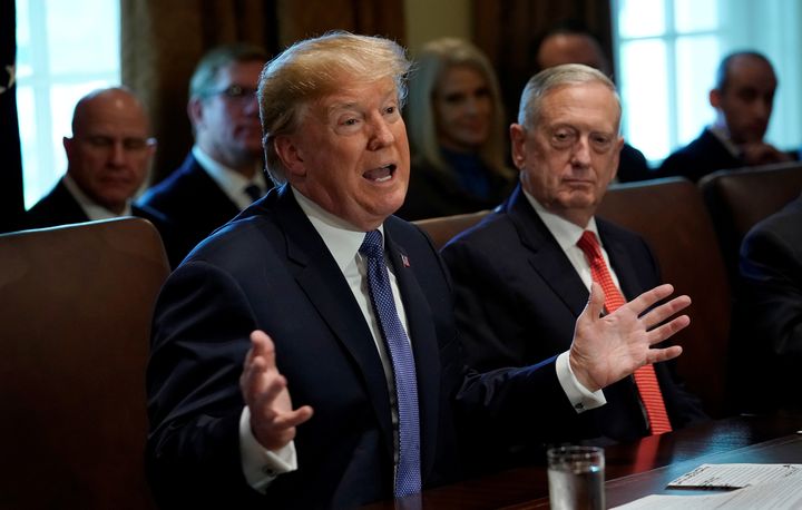 With Secretary of Defense James Mattis at his side, President Donald Trump speaks to his Cabinet on Nov. 1, 2017. A federal judge has blocked Trump's ban on transgender troops in the U.S. military.