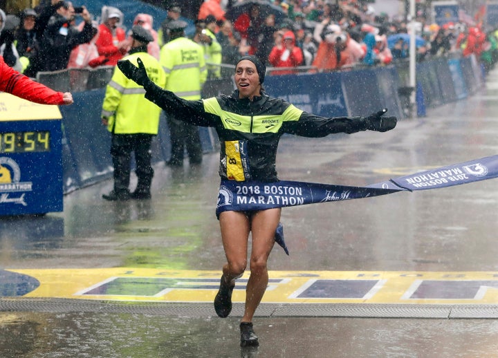 Desiree Linden of the USA hits the tape to win the Women's Division of the 2018 Boston Marathon.