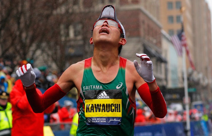 Yuki Kawauchi of Japan crosses the finish line to win the men's division of the 122nd Boston Marathon.