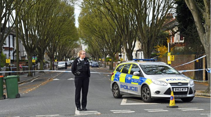 A police officer guards the scene where an 18-year-old man died from stab wounds in east London