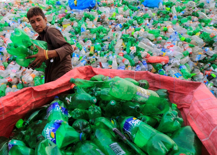 A worker sorts plastic bottles at a recycling workshop in Islamabad, Pakistan. 