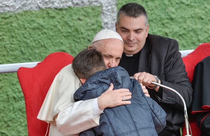 Pope Francis hugs a child named Emanuele at the&nbsp;St. Paul of the Cross parish during a pastoral visit on April 15, 2018.