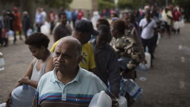 Residents line up in February to fill plastic water bottles and containers at a natural water spring on the site of a local brewery in Cape Town, South Africa. As a waterless Cape Town has become a potential reality, its story has sparked new concerns over the growing scarcity of the planet’s most basic resource.