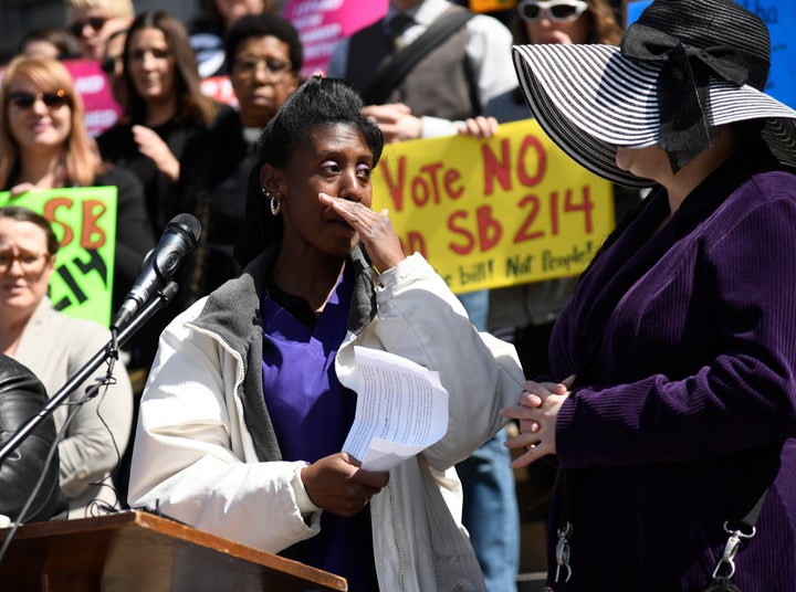 Care provider Brenda Lozada gets emotional after speaking against Colorado's Senate Bill 214 at a rally on the west steps of its Capitol in March. Lozada cares for people on Medicaid and is also a Medicaid recipient herself. SB 214 would institute work requirements for Coloradans on Medicaid.