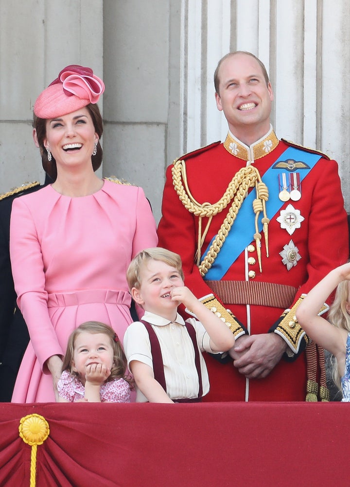 Catherine, Duchess of Cambridge, Princess Charlotte of Cambridge, Prince George of Cambridge and Prince William, Duke of Cambridge look out from the balcony of Buckingham Palace on June 17, 2017.