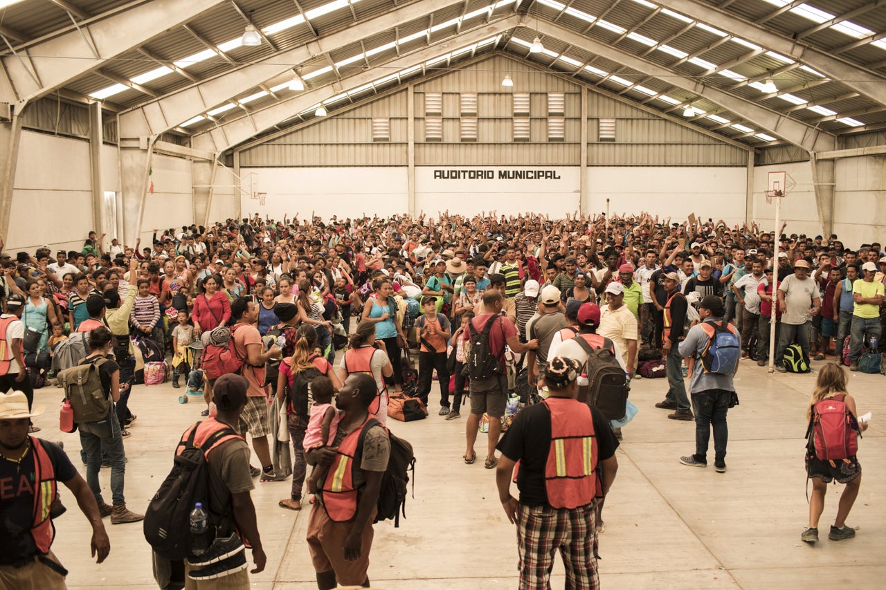 A group of Central American refugees and asylum-seekers, led by the collective Pueblo Sin Fronteras, waits for buses in Ixtepec, Mexico, on March 31.