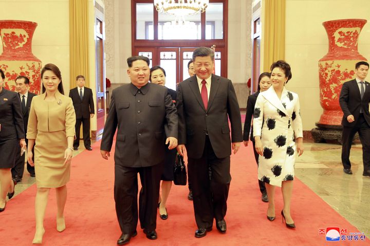 North Korean leader Kim Jong Un, his wife Ri Sol Ju, Chinese President Xi Jinping and his wife Peng Liyuan in an undated photo released by North Korea's Korean Central News Agency on March 28, 2018. 