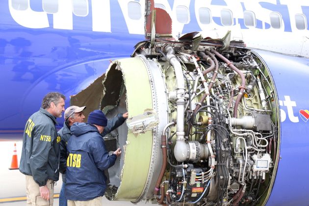 Investigators examine the damaged Southwest Airlines engine