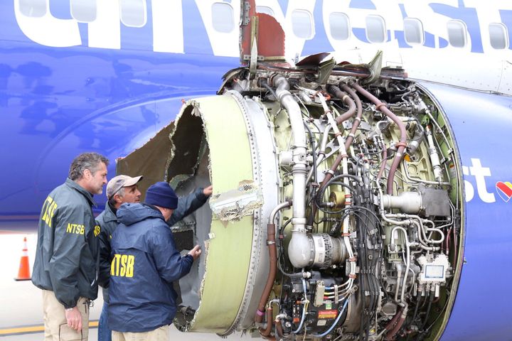 Investigators examine the damaged Southwest Airlines engine