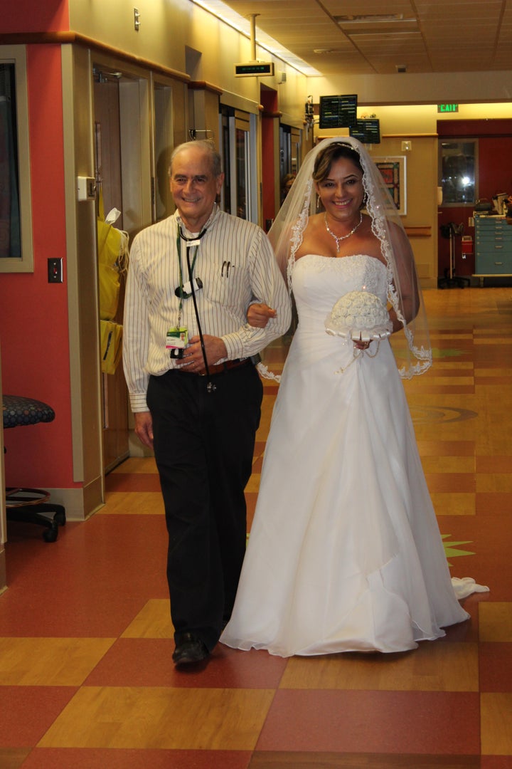 Kaelin’s neonatologist, Waldemar Carlo, M.D., walked the bride down a hospital hallway.