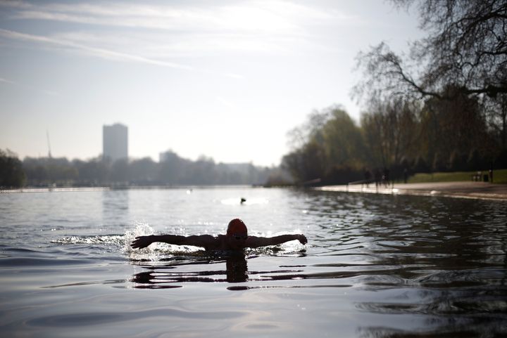 A swimmer goes for an early morning dip in the Serpentine, Hyde Park 