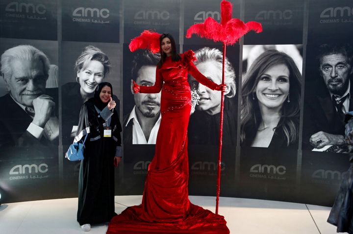 A woman poses at Saudi Arabia's first new commercial movie theater in Riyadh on April 18, 2018.