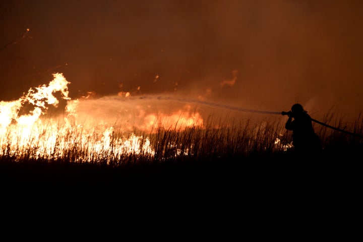 A firefighter works to control the Rhea wildfire near Seiling, Oklahoma, on April 17.