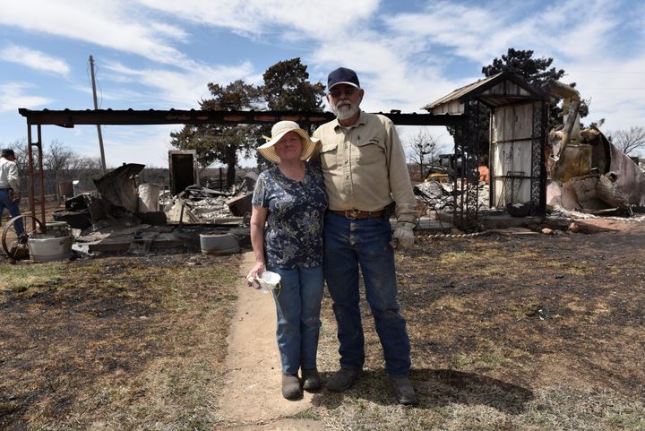 Arlinda and Larry Lynes stand in front of what remains of their home that was destroyed by the Rhea Fire near Taloga, Oklahoma, on. April 17.