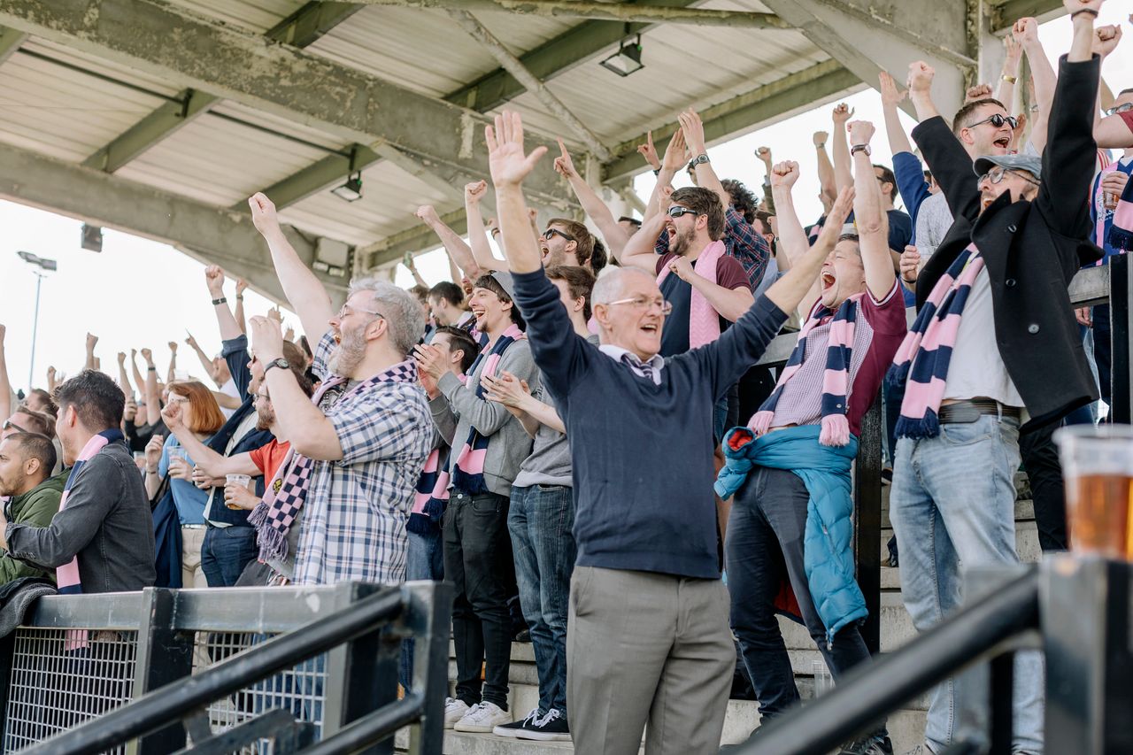 Dulwich Hamlet supporters celebrate a goal against Thurrock F.C. in an April match.