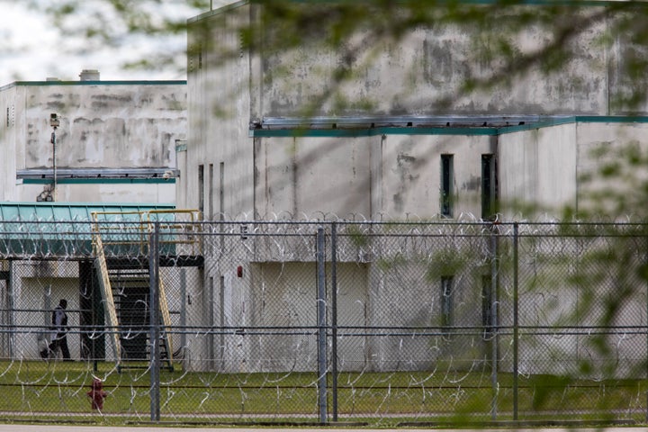 A guard walks between buildings at the Lee Correctional Institution, in Bishopville, South Carolina, on April 16, 2018.