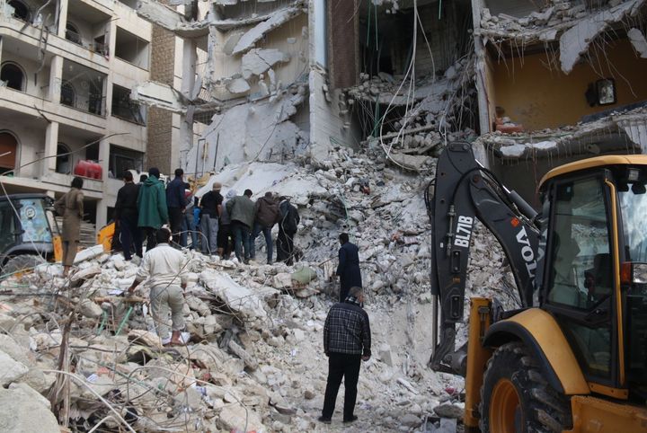 Syrian civil defense members conduct search and rescue operations at the site of the blast that leveled a seven-story building in Idlib, which Lord Richards has said the West should intervene to protect