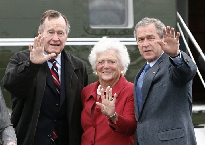 Former President George W. Bush (R) waves alongside his parents, former President George Bush and former first lady Barbara B