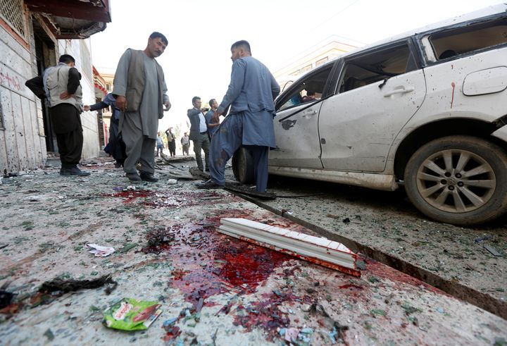 Afghan men inspect the site of a suicide bomb blast in Kabul, Afghanistan, on April 22, 2018. (REUTERS/Omar Sobhani)