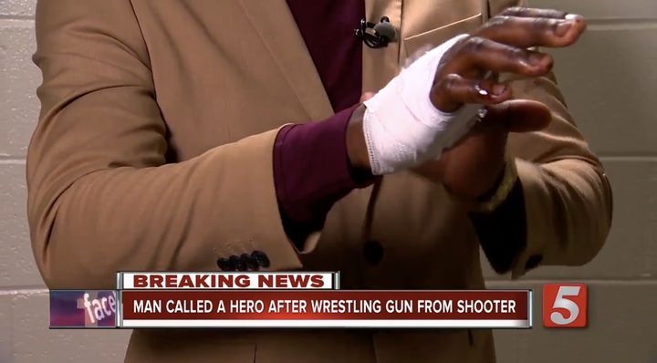 James Shaw, Jr. shows off his bandaged hand after disarming a gunman early Sunday morning.