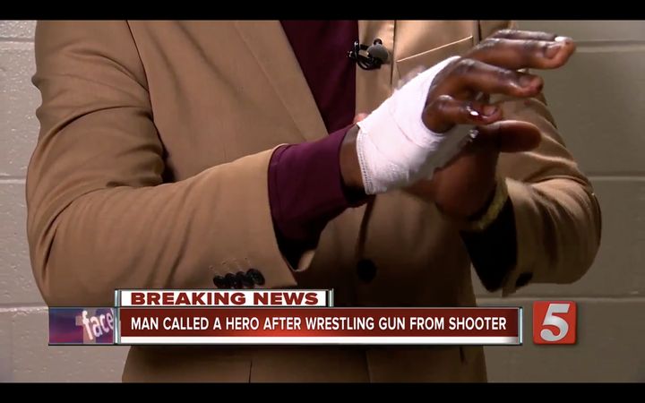 James Shaw, Jr. shows off his bandaged hand after disarming a gunman early Sunday morning.