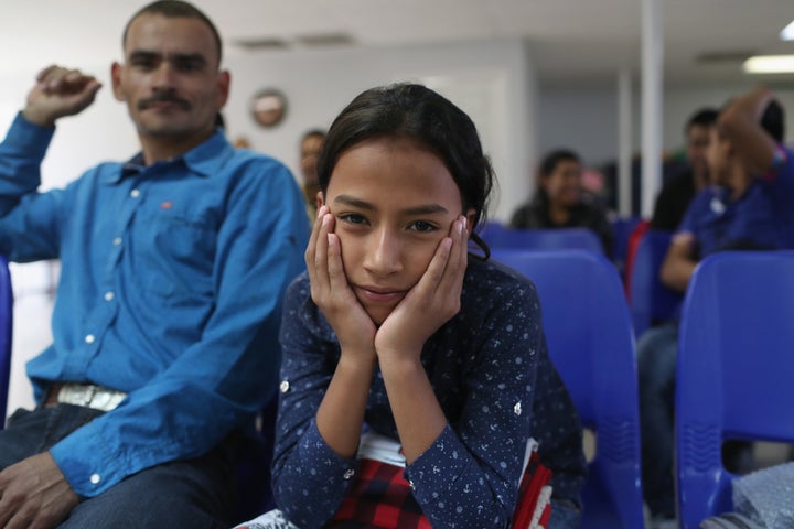 A father and daughter from Honduras wait for assistance at the Immigrant Respite Center after they were released from U.S. immigration officials on Feb. 23 in McAllen, Texas. 