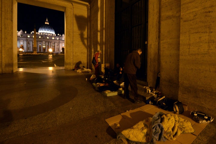 Homeless persons prepare to sleep under an arcade at the Vatican in November 2014.