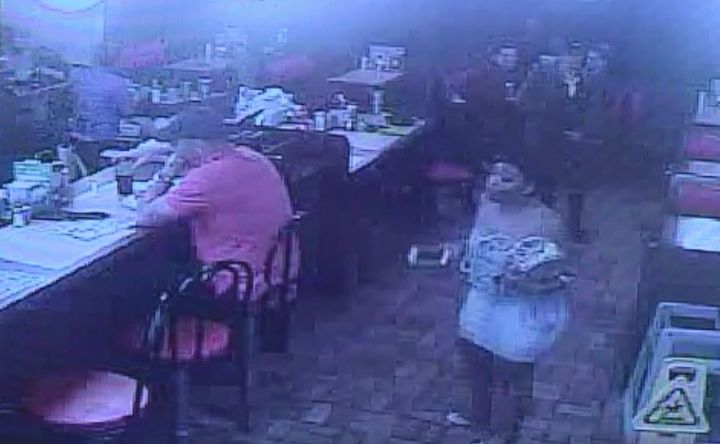 A still taken from a Waffle House surveillance video shows Chikesia Clemons approaching the restaurant's front counter.
