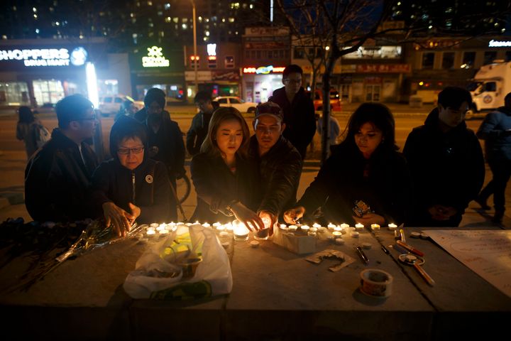 People left candles and messages at a memorial for victims of a crash late Monday.