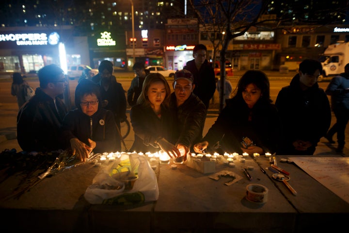 People left candles and messages at a memorial for victims of a crash late Monday.