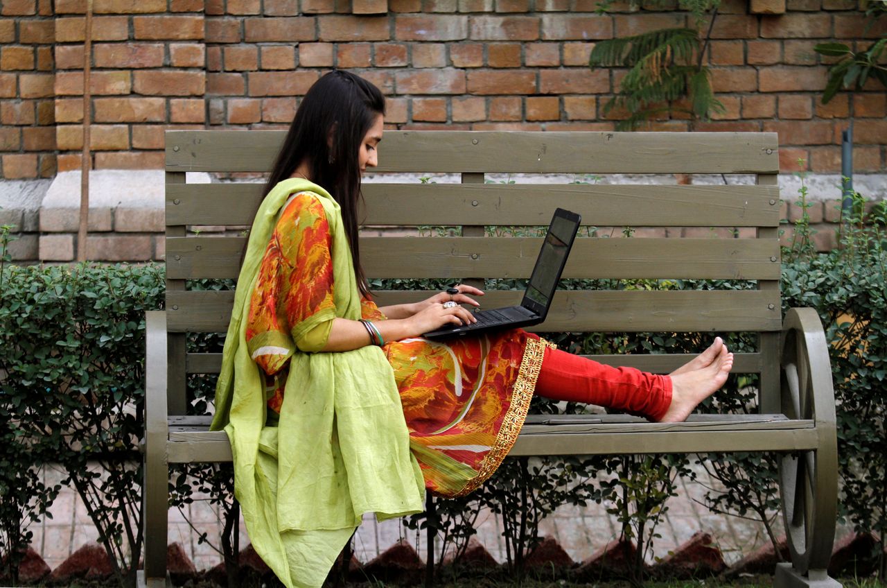A woman works on a bench on Peshawar, Pakistan. Some experts say the rise of gig work is transforming women's role in the workforce.