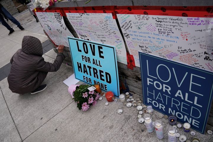 A mourner leaves a message at a makeshift memorial a day after the attack 