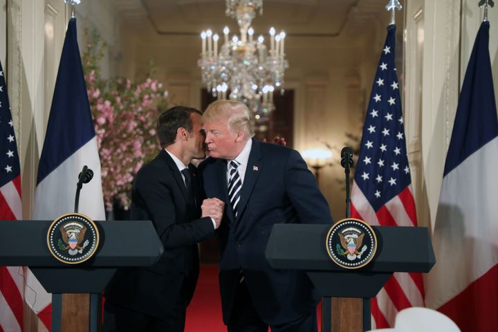 Donald Trump and Emmanuel Macron embrace as they hold a joint press conference at the White House.