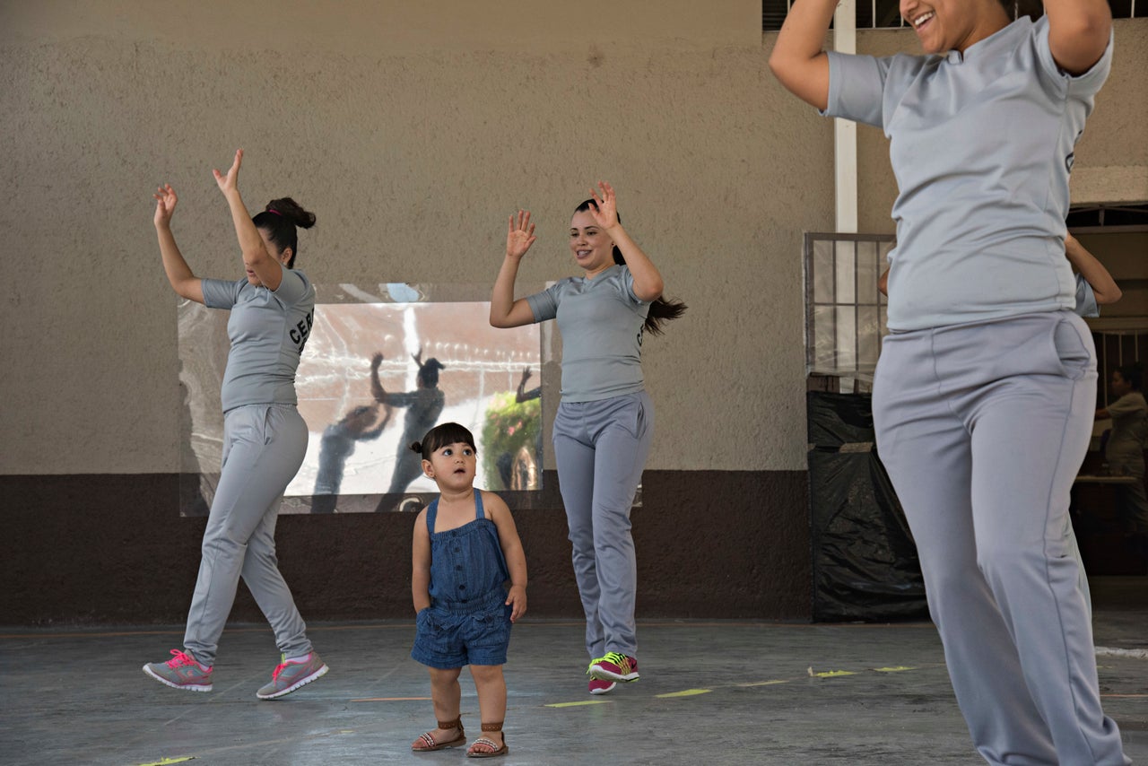 Melissa wanders through a room of dancing women during a morning Zumba class in the women's prison. Authorities arrested her mom six years ago for kidnapping. She says she was unaware of her husband's real job and that she never took part in it, but a judge handed her a 10-year sentence for the crime.