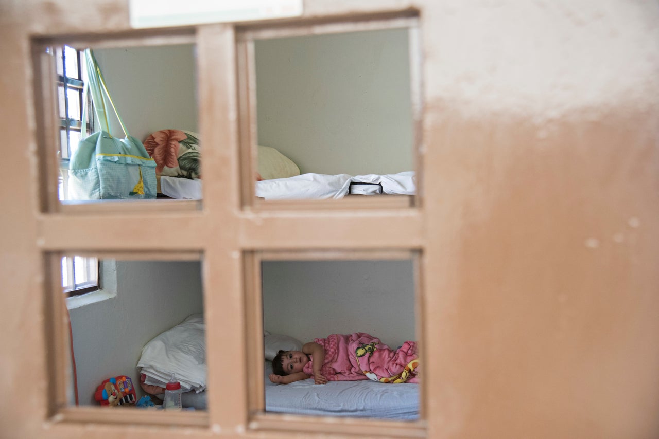 Melissa lies on the bunk she shares with her mom, watching Spongebob on TV while drifting off for an afternoon nap.