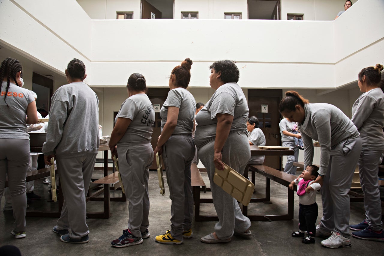 Women line up for lunch in the common area of the living quarters in the women's state prison in Chihuahua City, Mexico. 