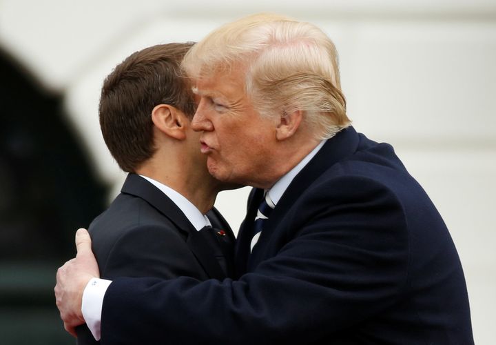 U.S. President Donald Trump kisses French President Emmanuel Macron during an arrival ceremony at the White House on Tuesday.