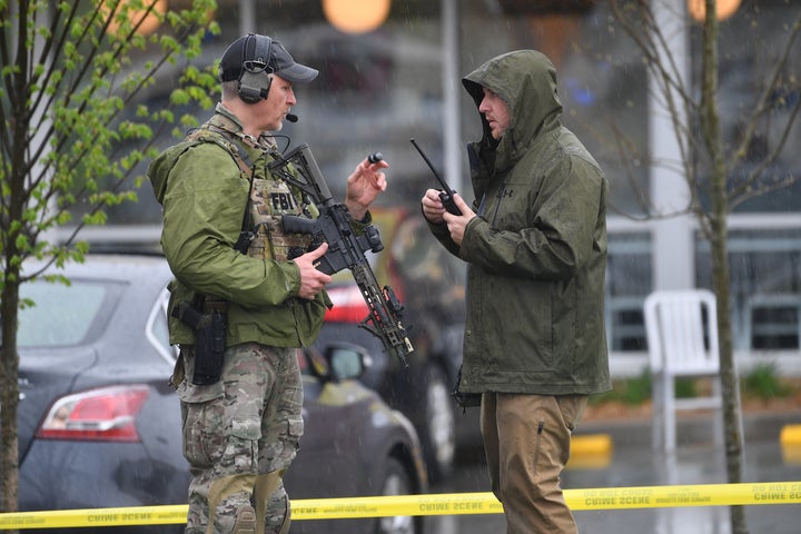 Law enforcement officers stand outside the Waffle House where four people were killed and two more wounded on April 22.