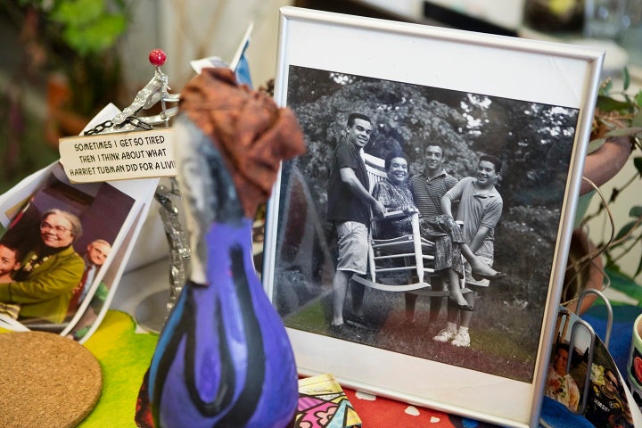 A close-up shot of Wright Edelman's office includes a photo of her three sons, Joshua, Jonah and Ezra, holding her up in