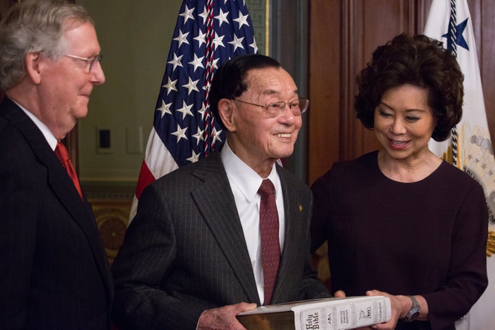 Elaine Chao is seen being sworn in as the transportation secretary with her father, James Chao, holding a Bible. Her husband, Senate Majority Leader Mitch McConnell, bears witness.