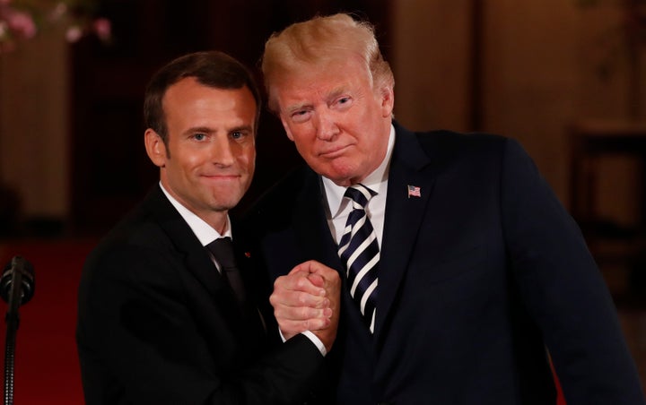 French President Emmanuel Macron clasps hands with U.S. President Donald Trump after their joint news conference at the White House Tuesday, April 24.