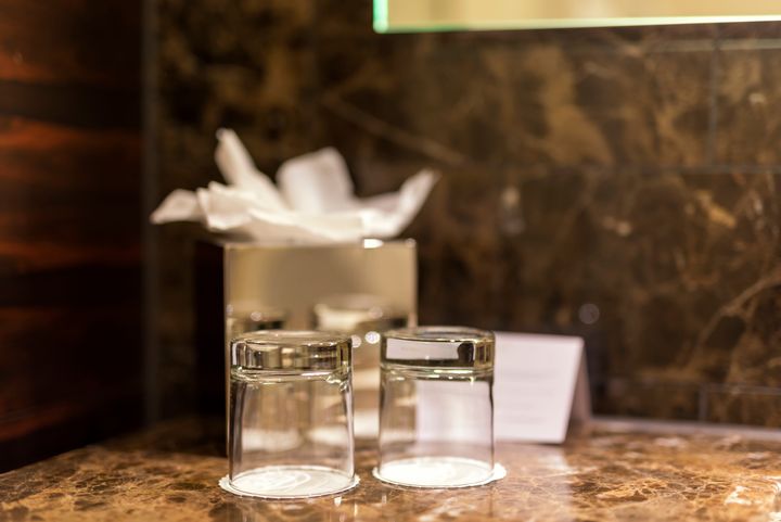 If your hotel room offers glasses instead of plastic cups, it's not a bad idea to clean them once more. They may not have been properly disinfected. 