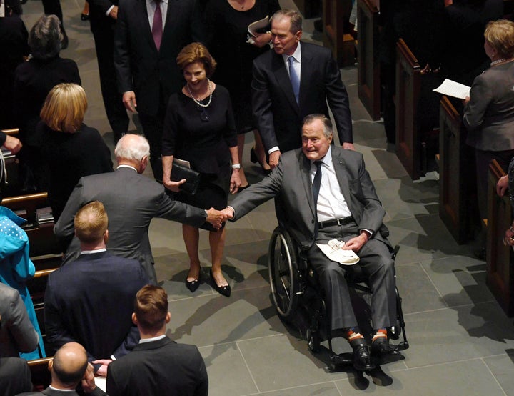 Former President George H.W. Bush is seen exiting the funeral services of his wife, Barbara, followed by his daughter-in