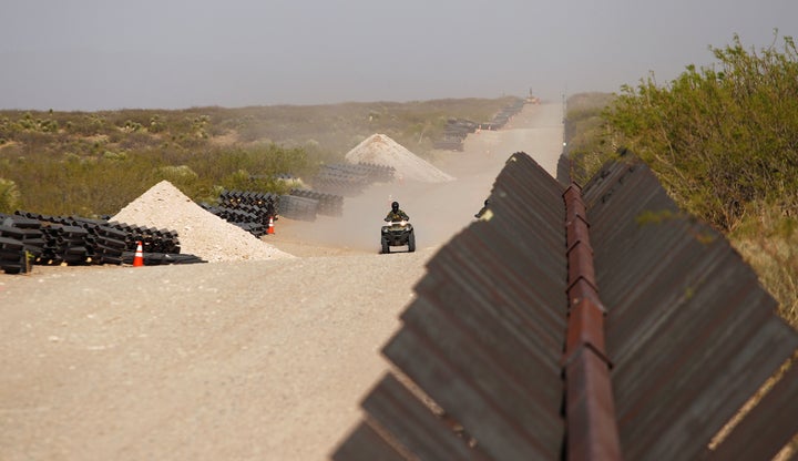 A U.S. Border Patrol agent rides his ATV along the border at the site of the construction of new wall in Santa Teresa, New Mexico, as seen from the Mexican side of the border in San Jeronimo on April 17. 